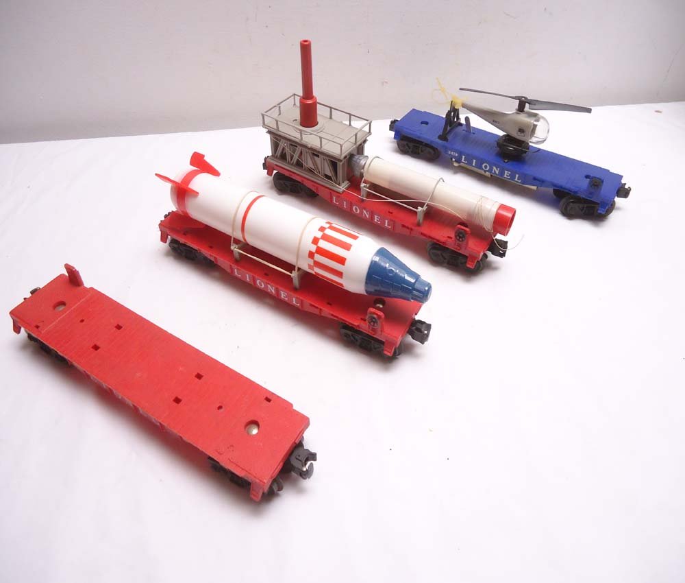 ABT: Lionel 4-item Military Rolling Stock: Paul V. Ambrose and Drew J. Bauer present: These are the #3413 Mercury Capsule Launcher, #6407 Flat Car w/reproduction Rocket, #3419 Flat Car w/Original Helicopter, and #6819 Flat Car only that Lionel