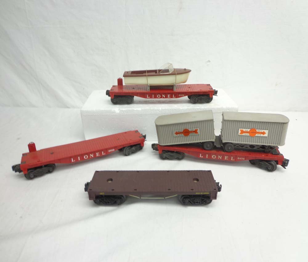 ABT: 4 Lionel Assorted Flar Cars: Paul V. Ambrose and Drew J. Bauer present: These are the #6801 Flat Car w/Boat, #6430 Flat Car w/Vans, #6800 (no Airplane), and #1877 Flat Cars that Lionel made in the 1950s. Our Opinion is that the L
