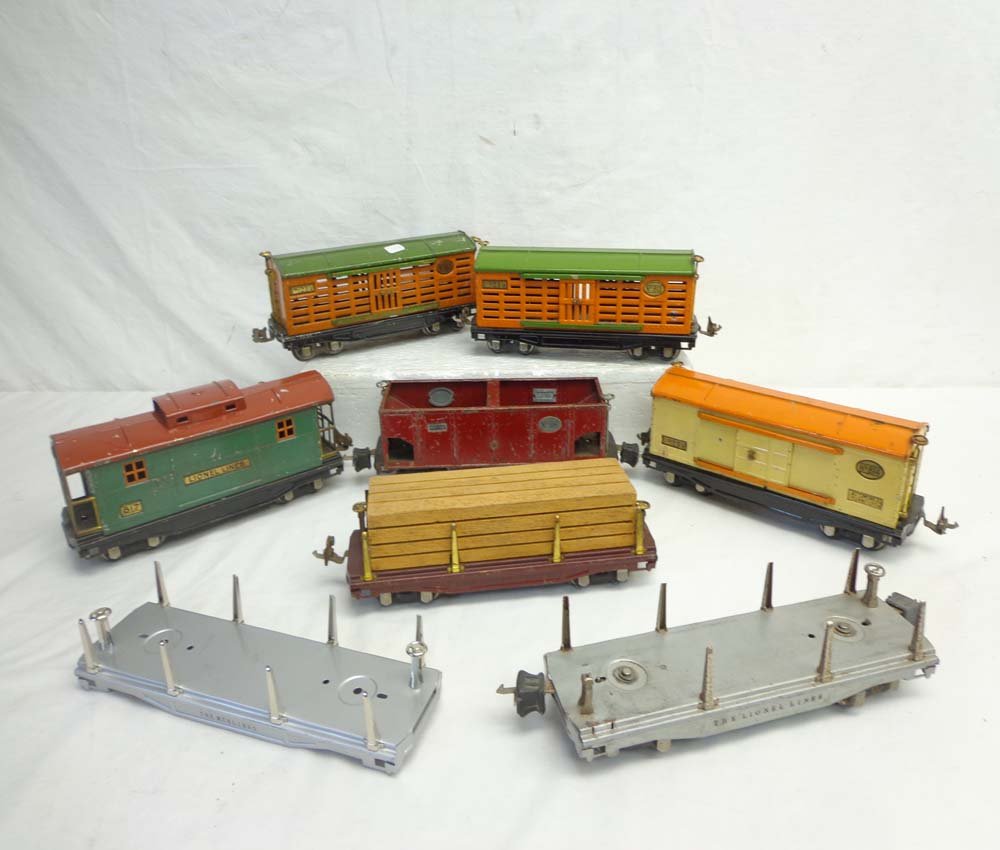 ABT: 8 Lionel/MTH Assorted Rolling Stock Items: Paul V. Ambrose and Drew J. Bauer present: These are two #813 Stock Cars, #814 Box Car, #816 Hopper, #817 Caboose, two #811 Flat Cars that Lionel made Pre War and one Modern Era MTH Flat Car. No Boxes