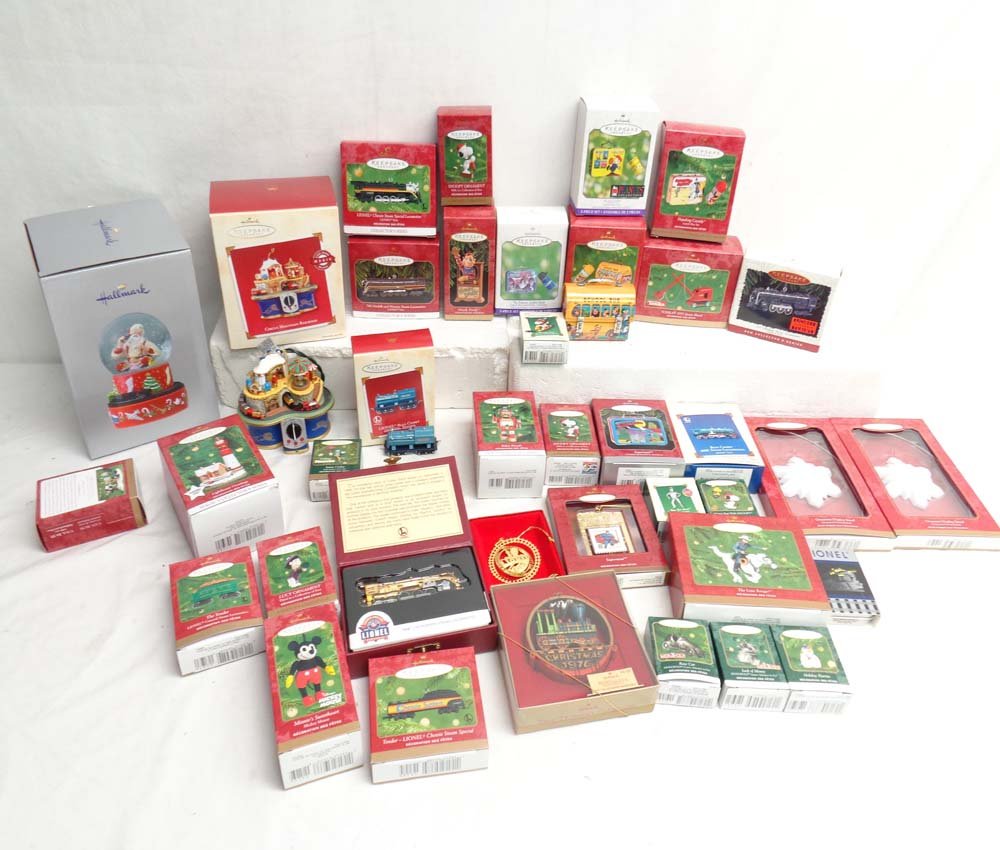 ABT: 35 Assorted Hallmark Christmas Ornaments, Snow: Paul V. Ambrose and Drew J. Bauer present: These are thirty-five Assorted Hallmark Christmas Ornaments, Snow Globe, Display Stands and 1 Lionel Zippo Lighter. Original Boxes. All Original in our Opini