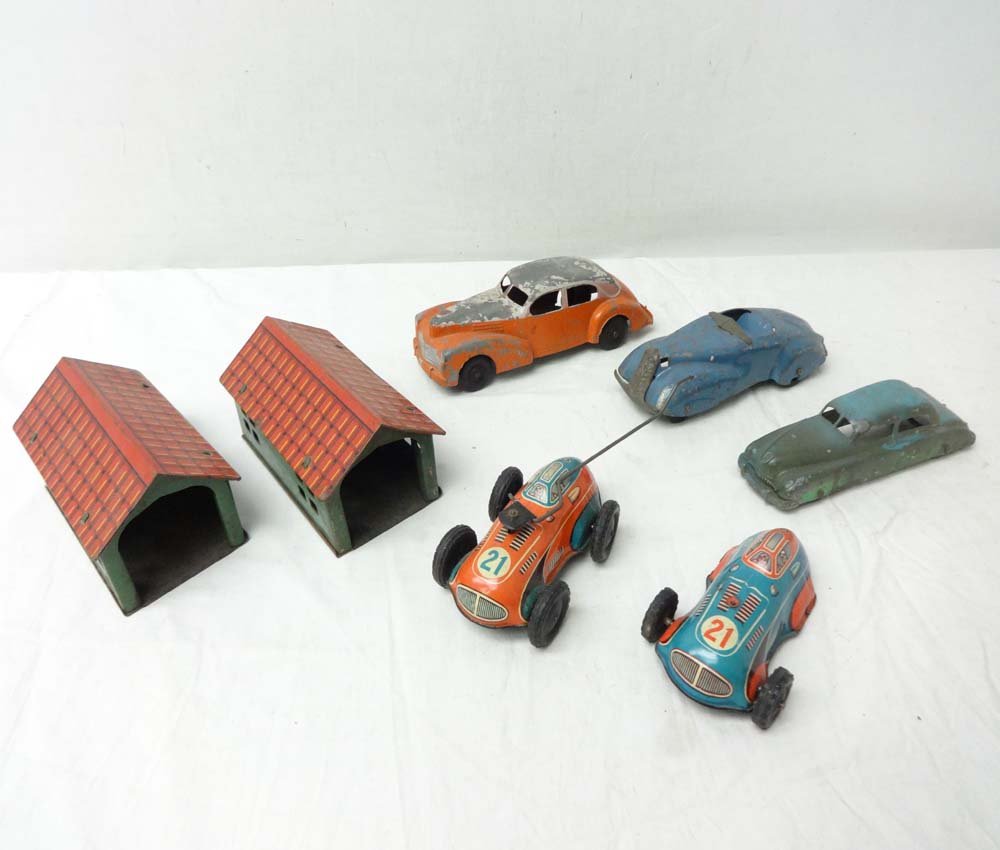 ABT: Assortment Die-cast/Tinplate Vehicles & 2 Garages: Paul V. Ambrose and Drew J. Bauer present: These are five die-cast and tinplate Toy Vehicles and two Garages that were made in W. Germany and elsewhere from time long ago. Measurements are from bigges