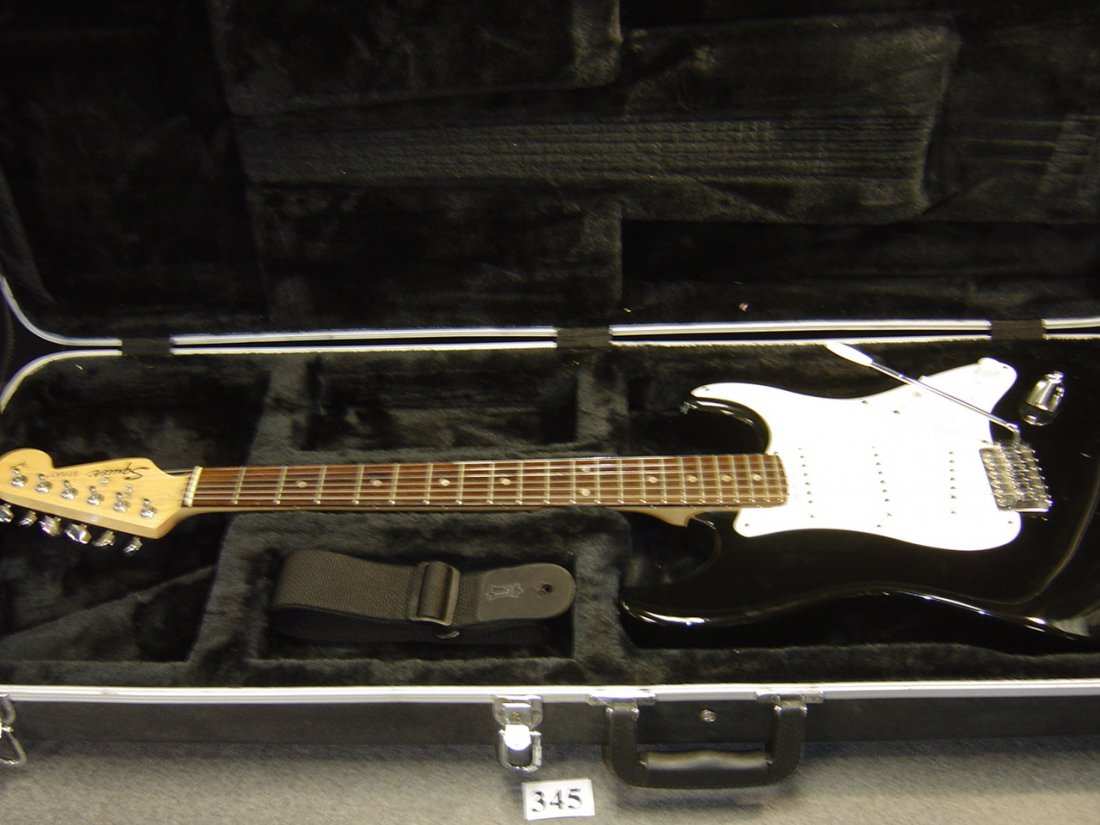 SQUIRE STRAT ELECTRIC GUITAR W/ HARD CASE: STRAP AND CASE INCLUDED. NO KEY FOR CASE. THE GUITAR IS USED BUT IN DECENT PLAYABLE CONDITION.