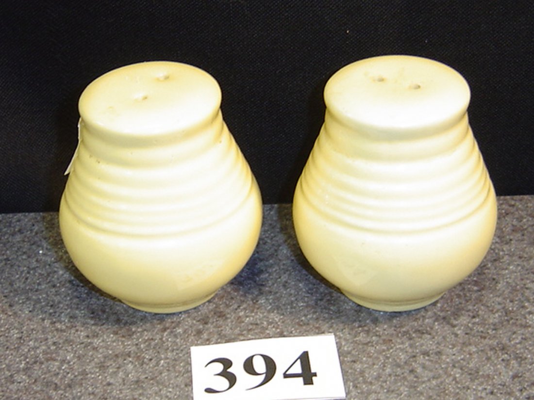 PAIR OLD YELLOW FIESTA SALT/PEPPER: ABOUT 3 INCHES TALL. THE TOP DIAMETER IS ABOUT 1 1/4. NO CHIPS/CRACKS.