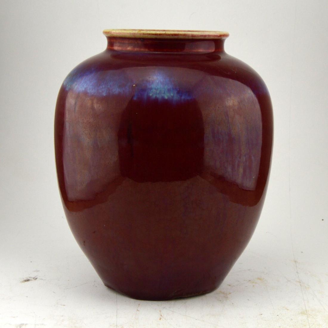 Flambe Glazed Amphora Vase: A red flambe glazed wide amphora vase carrying some iridescent blue and purple in the glaze.