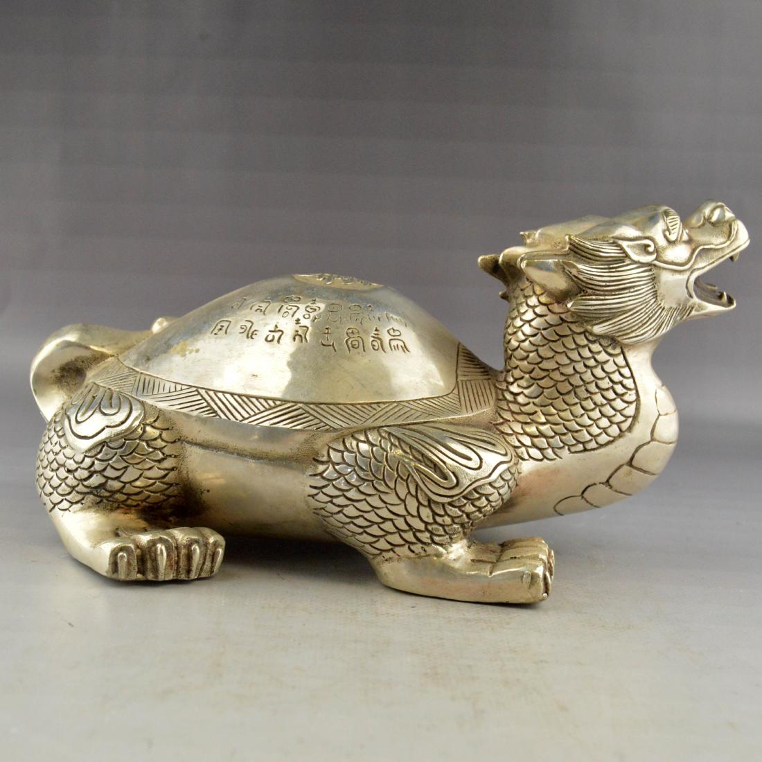 Gilt Bronze Dragon Statue: 銅鎏銀龍龜A white gilt bronze crafted dragon-turtle carved with detail and Chinese characters on the shell. ; Height 1.75 inch ; Width 5 inch ; Length 10 inch ; Weight