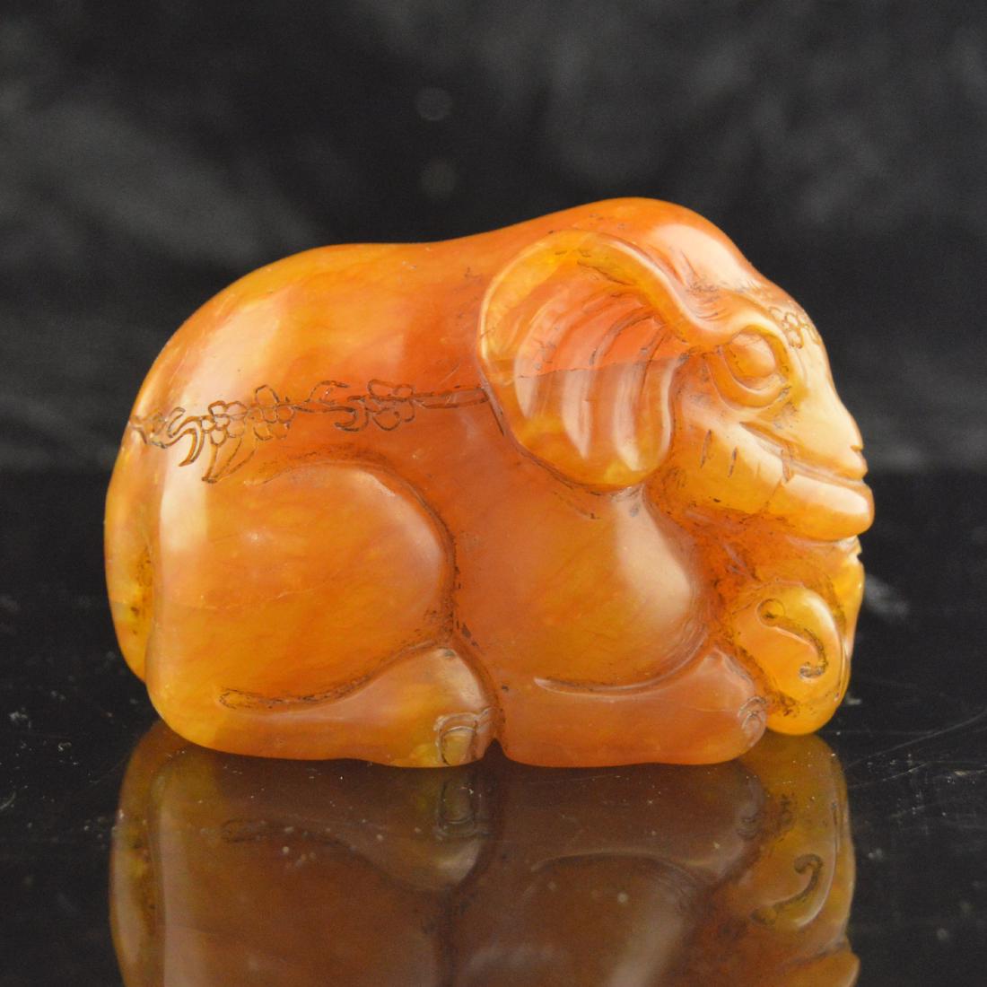 Soapstone Carved Elephant: 壽山石雕大象擺件 A vibrant red-orange soapstone or 'Shoushan' stone carved decorative pendant. An intricately detailed elephant with a floral crown etch