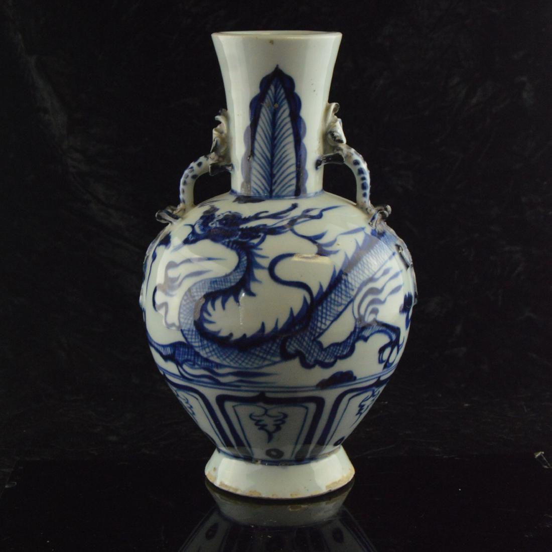 Amphora Dragon Vase: 青花雙耳繪龍瓷瓶 A "Phoenix Tail" or 'Yen-Yen' shaped vase with twin decorative handles and blue and white glazing depicting an eastern dragon along the