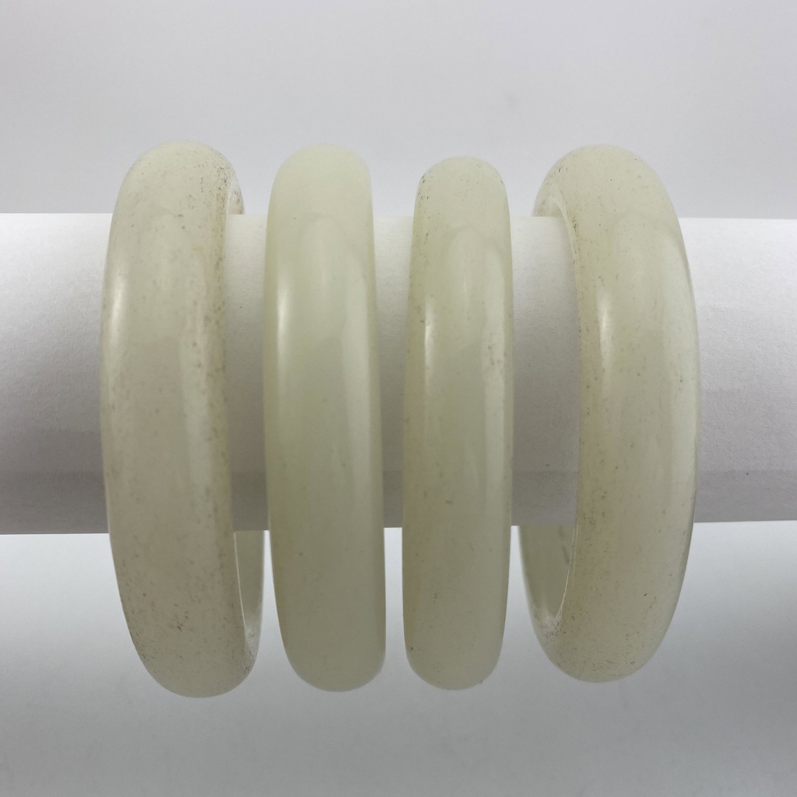 A Set of Four Natural White Jade Bangles (1 of 3)