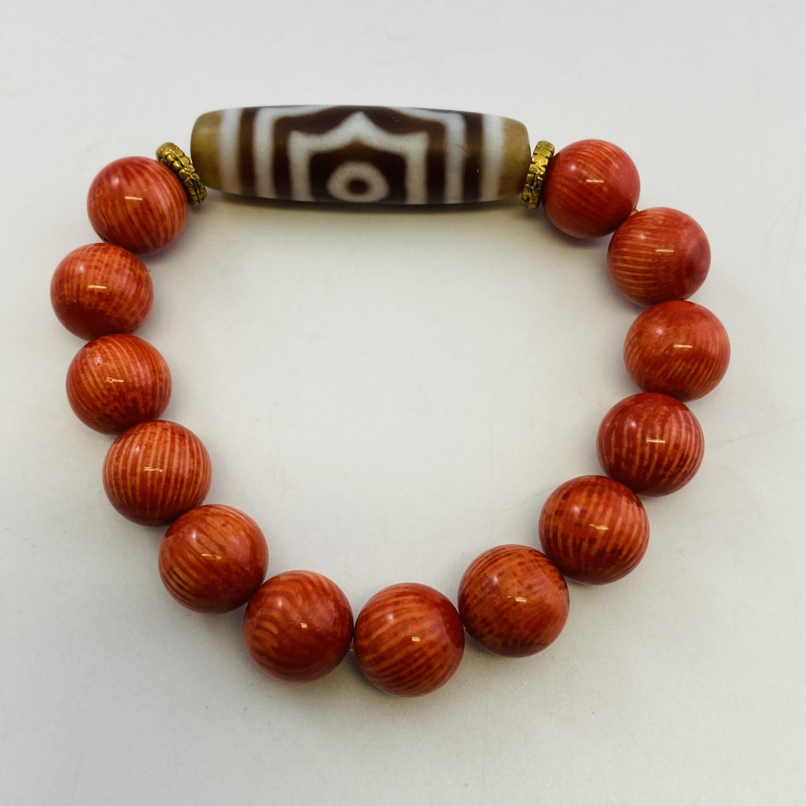 Coral and Dzi Bead Bracelet: Coral and Dzi Bead Bracelet. Bead Size: 3.9*1.1*1.1cm