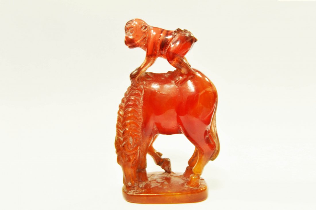 Amber Monkey Riding Horse Statuette: A Carved Amber Statuette, depicting a Monkey riding a horse. The Statuette is Approximately 4in Height, 2in Wide, and 1in Thick琥珀马上封