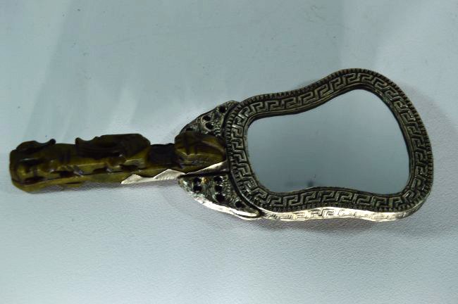 Antique Silver and Jade Phoenix and Dragon Hand Mirror: Antique Phoenix and Dragon etched Silver Hand Mirror with Jade Base, embedded with a green and red stone..