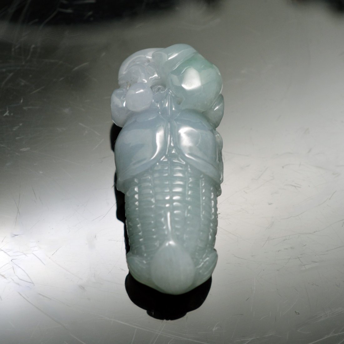 Natural Burma Icy Jadeite Carved Corn Pendant: A pendant made of natural Burma icy jadeite; carving a corn; ----- L x 1.000" H x 2.250" W x 0.750" 47.200g