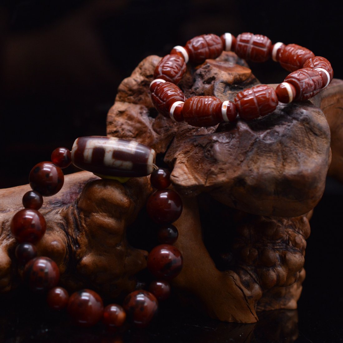 Swastika Dzi Bead Bracelet + Agate Carved Bracelet: A set of 2 bracelets; one made of a Swastika dzi bead and agate beads (A); one made of carved agate barrel beads (B); ------ A: D x 2.125" 41.400g; B: D x 2.125" 36.400g