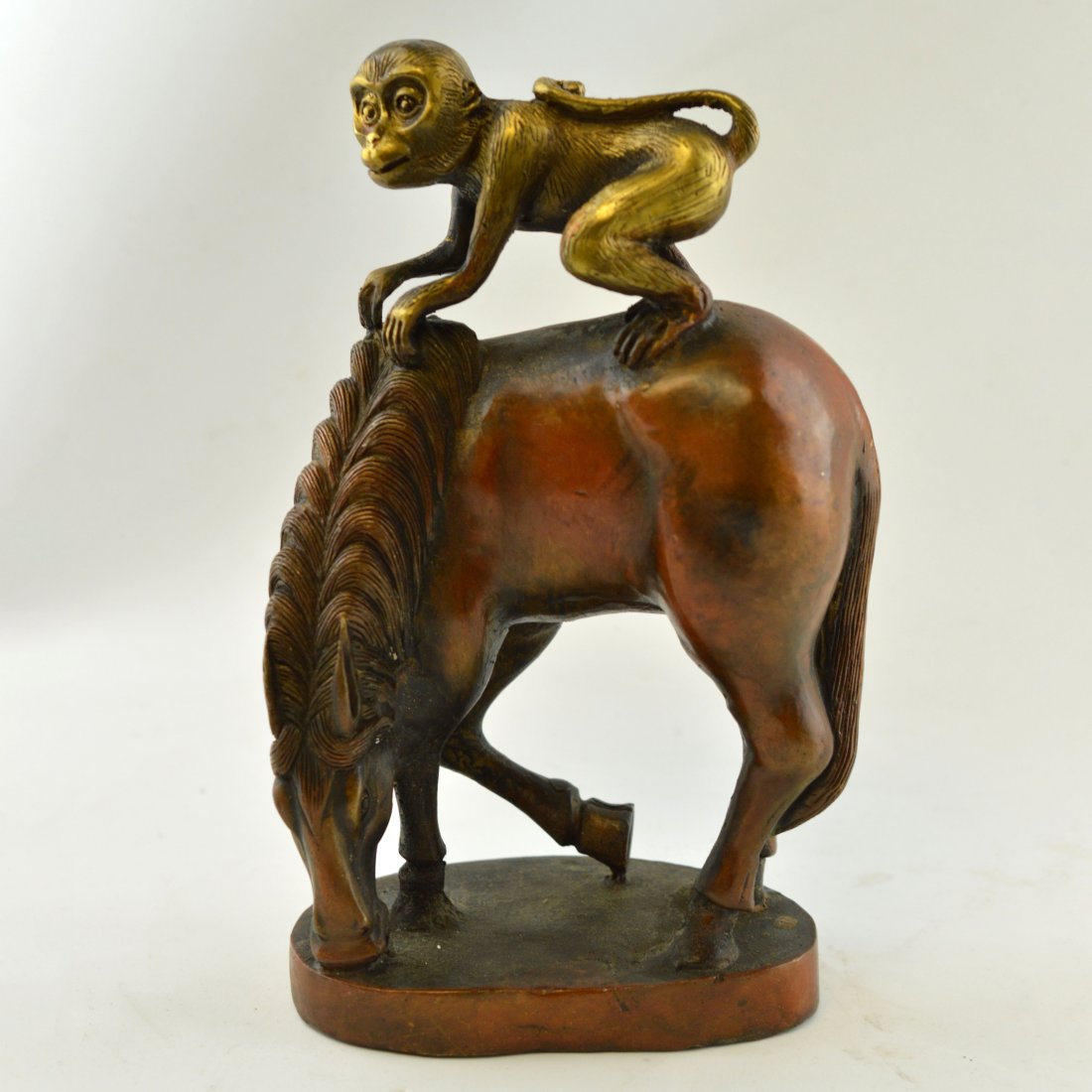 Copper Carved Statue: A statue made of copper; depicting a monkey riding a horse; ------ L x 5.375" W x 3.375" H x 8.250"