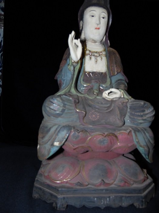 A Finely Carved Camphorwood Guan-Yin Seated on Lotus: A vintage camphorwood color Guan-Yin wearing robe and gilt necklace is seated on lotus with prayer gesture to deliver all living creatures from torment. finely carved wood Guan-Yin and beautiful color