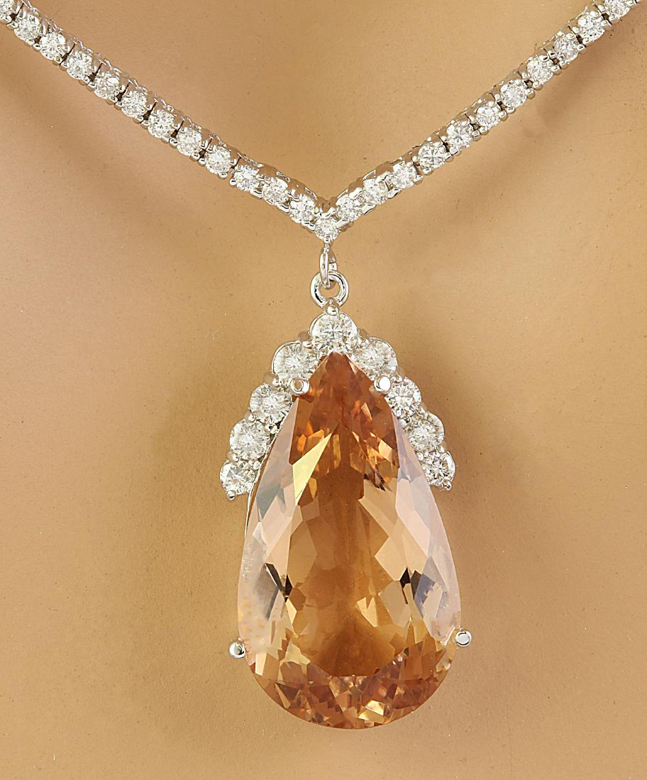15.65 Carat Morganite 18K White Gold Diamond Necklace: Stamped: 18K Total Necklace Weight: 18.3 Grams Necklace Length: 16 Inches Morganite Weight: 13.30 Carat (22.60x13.00 Millimeters) Diamond Weight: 2.35 Carat (F-G Color, VS2-SI1 Clarity) Face Measures: