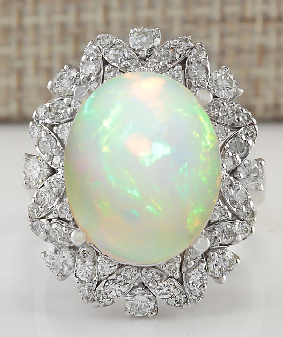 8.15 Carat Natural Opal And Diamond Ring In 18K White: Stamped: 18K Ring Size: 7.8 Total Ring Weight: 6.75 Grams Diamond Weight: Total natural diamond weight is 1.10carat. VS2-SI1 clarity / F-G color Gemstone Weight: Total Natural Opal Weight is 7.05ctw (