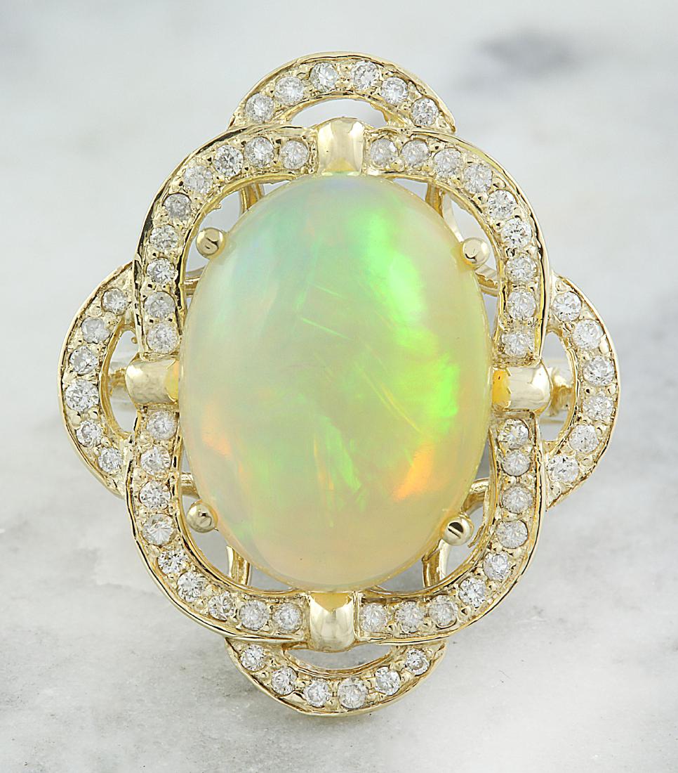 7.05 Carat Opal 18K Yellow Gold Diamond Ring: Stamped: 18K Total Ring Weight: 7 Grams Opal Weight 6.55 Carat (16.00x12.00 Millimeters) Diamond Weight: 0.50 carat (F-G Color, VS2-SI1 Clarity ) Face Measures: 25.40x21.55 Millimeter SKU: [600744]