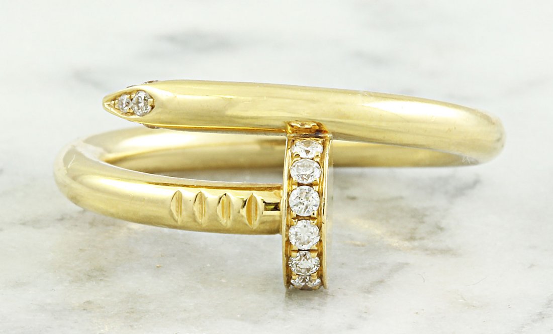 Authentic Cartier Juste Un Clou 0.13 Carat Diamond 18K: Stamped: 750 Ring Sizr 7.75 Total Ring Weight: 7.4 Grams Diamond Weight: 0.13 carat (F-G Color, VS2-SI1 Clarity ) Diamond Quantity 22 Face Measures: 10.20 Millimeter