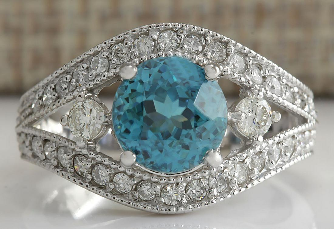 4.16Carat Natural Blue Zircon And Diamond Ring 18K: Stamped: 18K Ring Size: 7.25 Total Ring Weight: 5.5 Grams Diamond Weight: Total natural diamond weight is .70carat. VS2-SI1 clarity / F-G color Gemstone Weight: Total Natural Blue Zircon Weight is 3.4