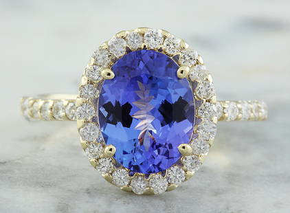 3.24 CTW Tanzanite 18K Yellow Gold Diamond Ring: 3.24 CTW Tanzanite 18K Yellow Gold Diamond Ring Manufacturer's Suggested Retail Price: $ 5950.00 Stamped: 18K Ring Size: 7 Total Ring Weight: 3.00 Grams Tanzanite Weight: 2.60 Carat