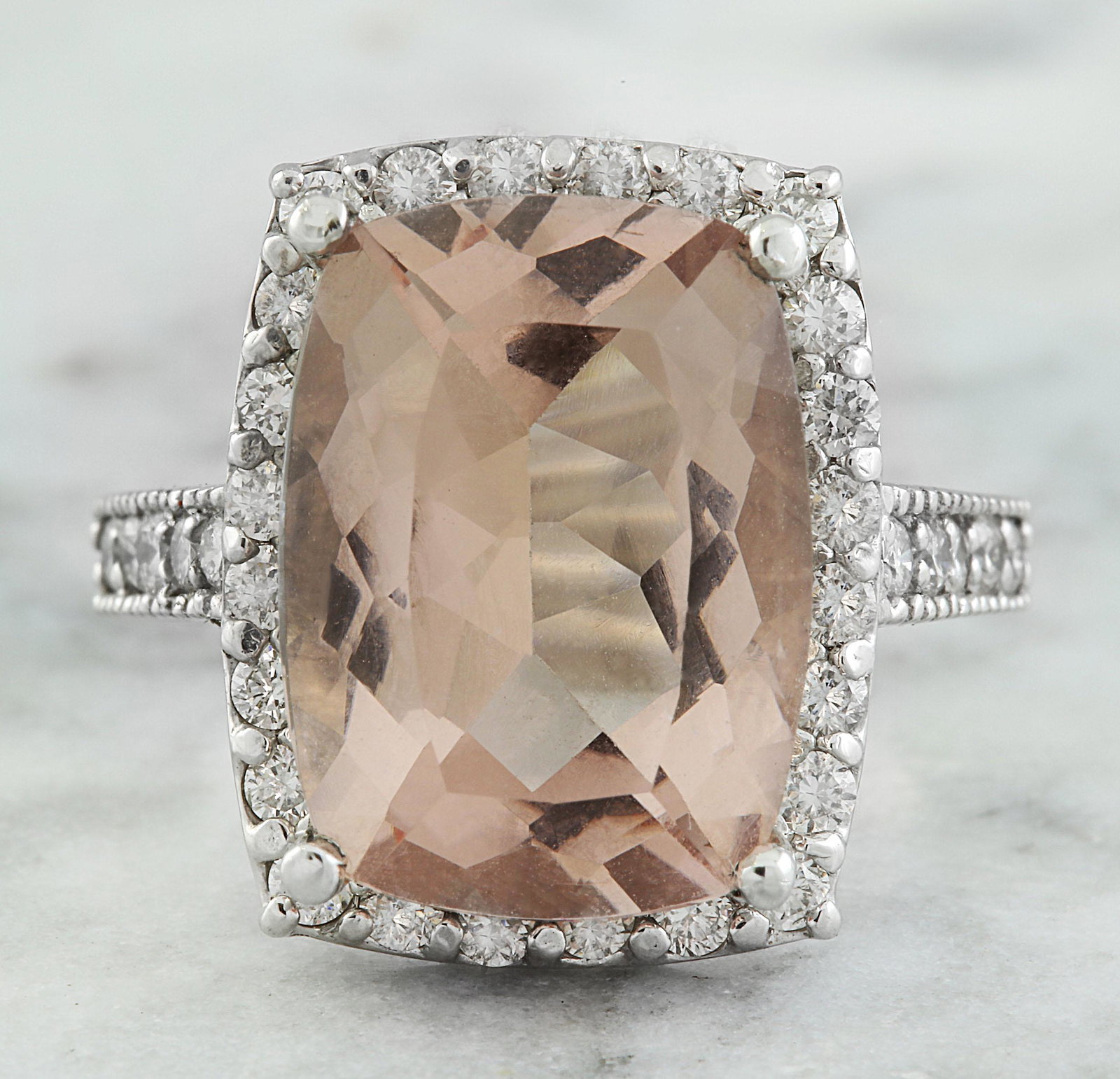 7.10 CTW Morganite 14K White Gold Diamond Ring: 7.10 CTW Morganite 14K White Gold Diamond Ring Manufacturer's Suggested Retail Price: $ 6250.00 Stamped: 14K Total Ring Weight: 6.6 Grams Morganite Weight: 6.30 Carat (14.70x10.80 Millimeters) Diamond