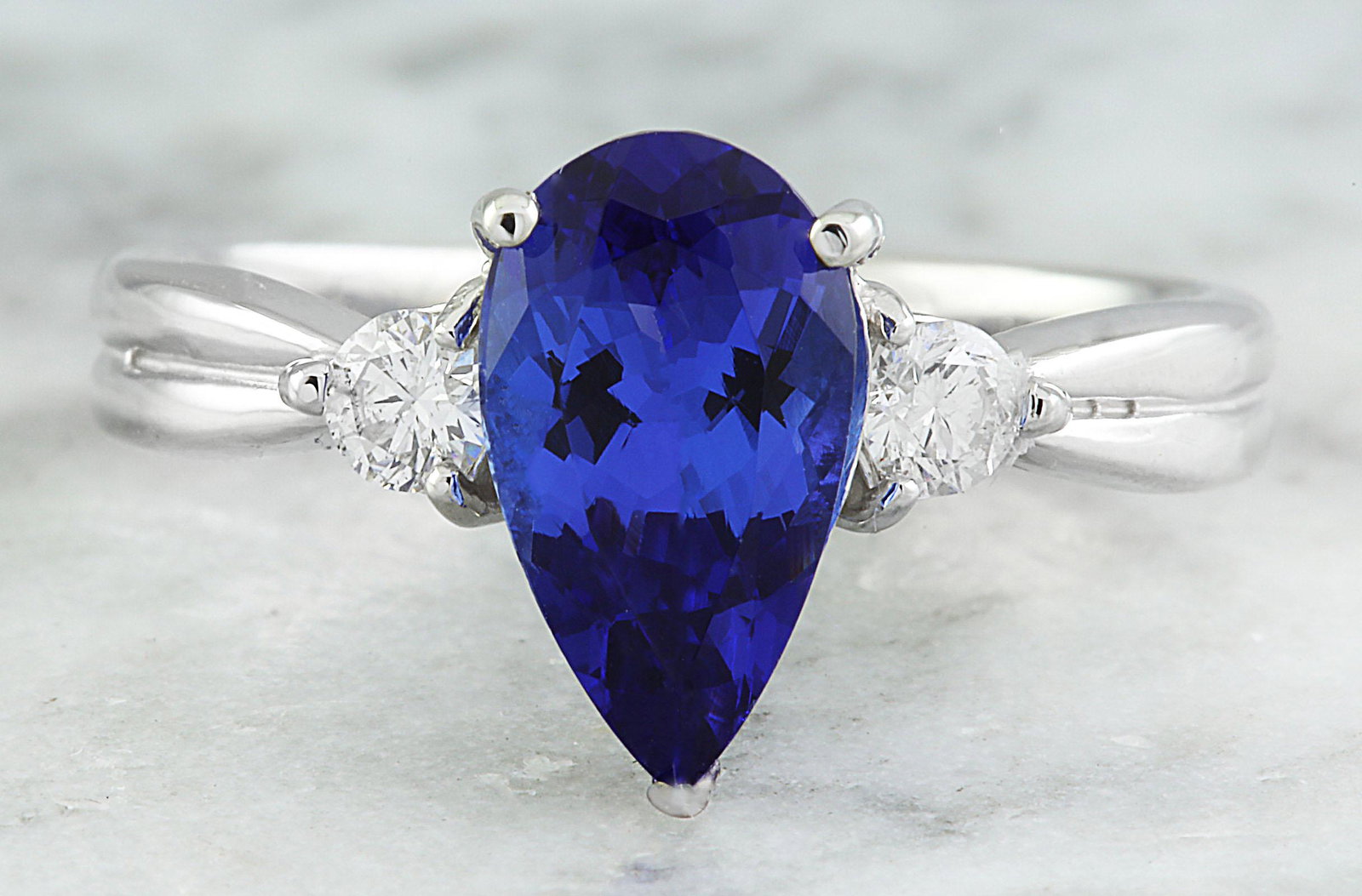 1.70 CTW Tanzanite 18K White Gold Diamond Ring: 1.70 CTW Tanzanite 18K White Gold Diamond Ring Manufacturer's Suggested Retail Price: $ 2950.00 Stamped: 18K Total Ring Weight: 3.1 Grams Tanzanite Weight 1.53 Carat (10.70x6.00 Millimeters) Diamond W