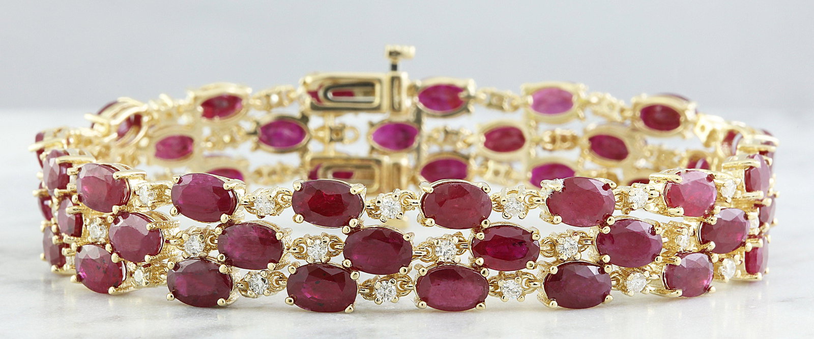 38.40 CTW Ruby 14K Yellow Gold Diamond Bracelet: 38.40 CTW Ruby 14K Yellow Gold Diamond Bracelet Manufacturer's Suggested Retail Price: $ 14500.00 Stamped: 14K Total Bracelet Weight: 32.6 Grams Bracelet Length: 7 Inches Ruby Weight: 36.60 Carat (6.0