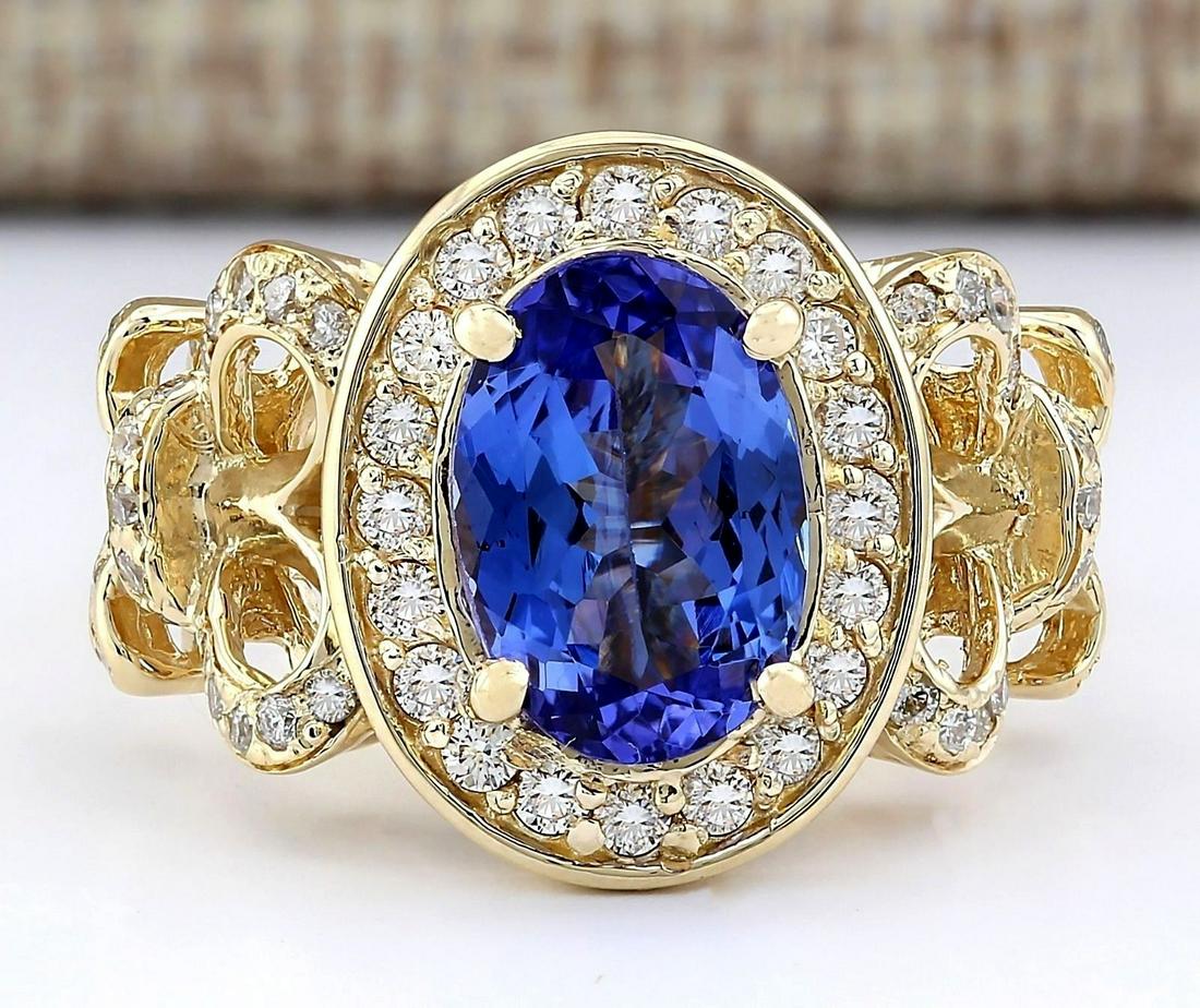 3.93 CTW Natural Tanzanite And Diamond Ring In 18K: 3.93 CTW Natural Tanzanite And Diamond Ring In 18K Yellow Gold Manufacturer's Suggested Retail Price: $ 7600.00 Stamped: 18K Ring Size: 7 Total Ring Weight: 9.1 Grams Diamond Weight: Total Natural dia