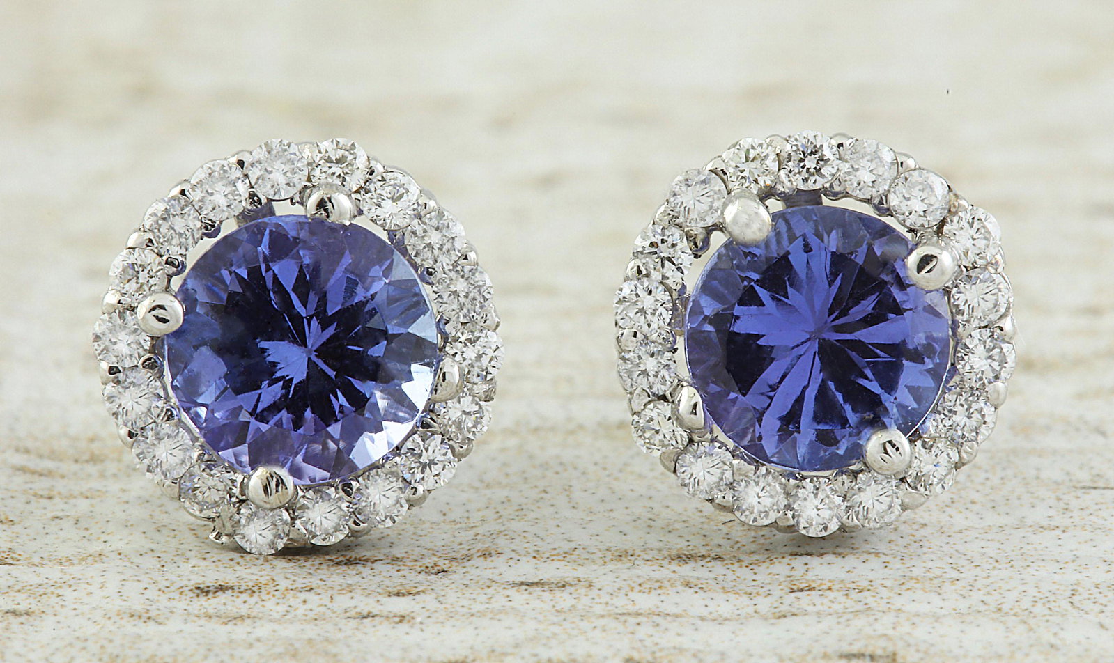 2.40 CTW Tanzanite 14K White Gold Diamond Earrings: 2.40 CTW Tanzanite 14K White Gold Diamond Earrings Manufacturer's Suggested Retail Price: $ 2800.00 Stamped: 14K Total Earrings Weight: 2 Grams Tanzanite Weight: 2.00 Carat (6.00x6.00 Millimeters) Dia