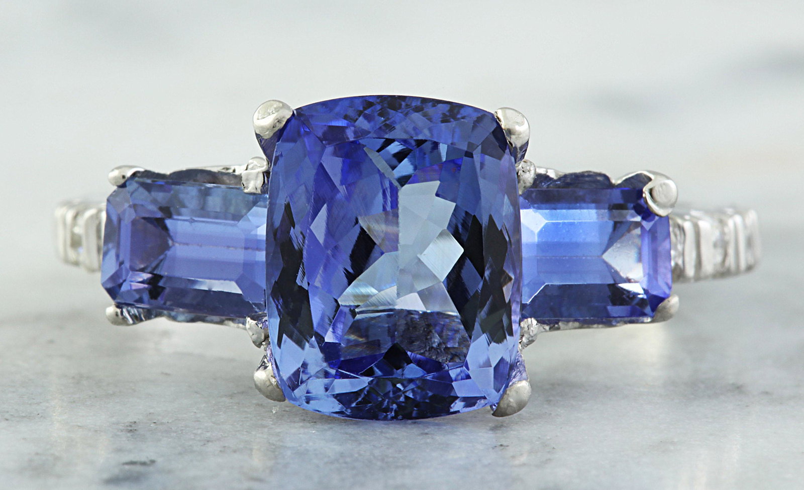 2.87 CTW Tanzanite 18K White Gold Diamond Ring: 2.87 CTW Tanzanite 18K White Gold Diamond Ring Manufacturer's Suggested Retail Price: $ 4400.00 Stamped: 18K Ring Size: 7 Total Ring Weight: 3.5 Grams Tanzanite Weight: 2.70 Carat (9.50x7.50 Millimete