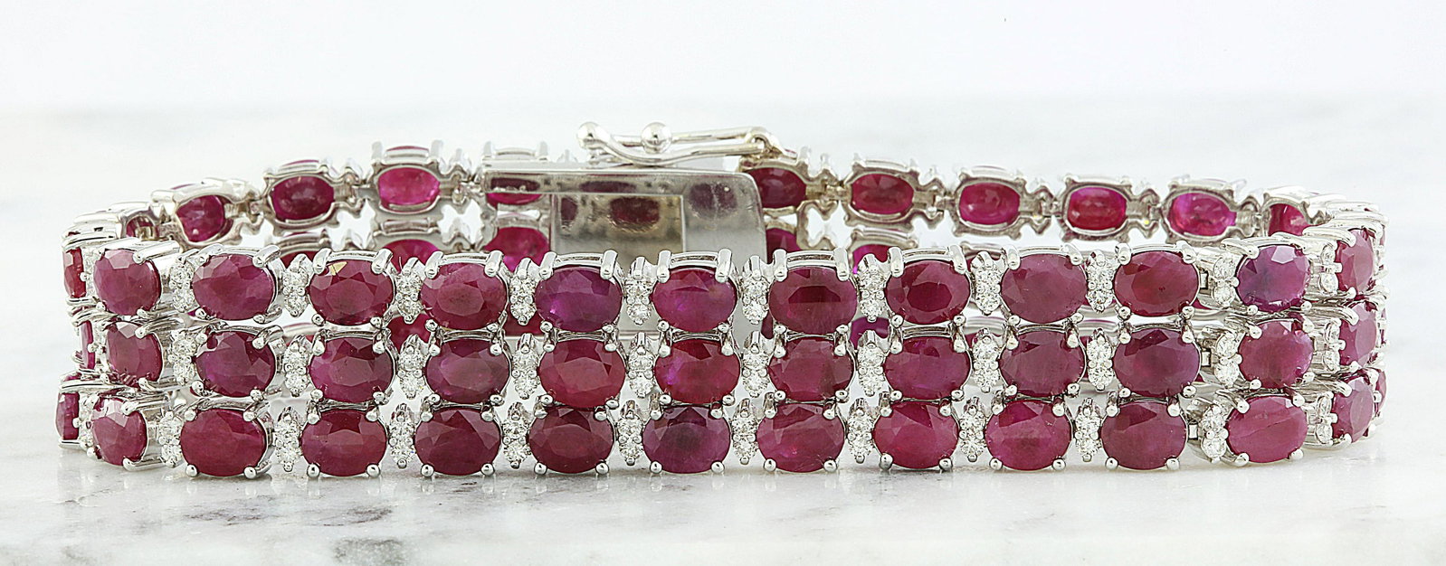 43.00 CTW Ruby 14K White Gold Diamond Bracelet: 43.00 CTW Ruby 14K White Gold Diamond Bracelet Manufacturer's Suggested Retail Price: $ 22950.00 Stamped: 585 Total Bracelet Weight: 41 Grams Bracelet Length: 7 Inches Ruby Weight: 40.00 Carat (5.00x4