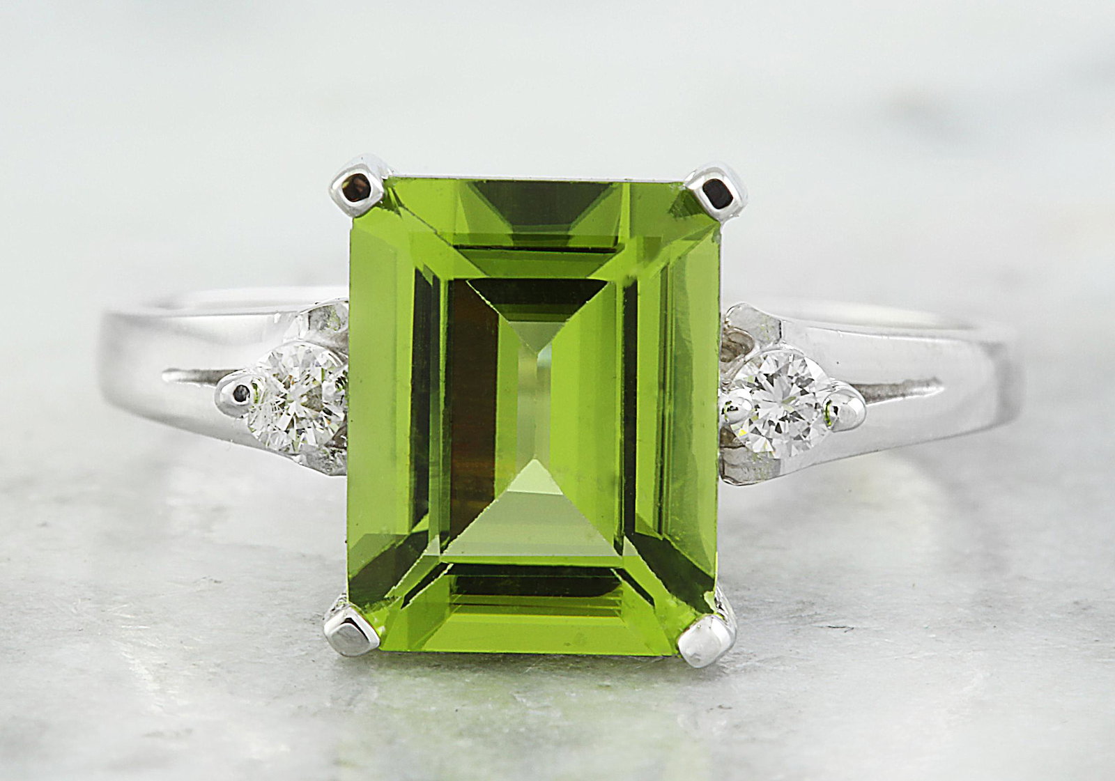 2.26 CTW Peridot 14K White Gold Diamond Ring: 2.26 CTW Peridot 14K White Gold Diamond Ring Manufacturer's Suggested Retail Price: $ 1900.00 Stamped: 14K Total Ring Weight: 2.9 Grams Peridot Weight 2.20 Carat (9.20x7.20 Millimeters) Diamond Weight