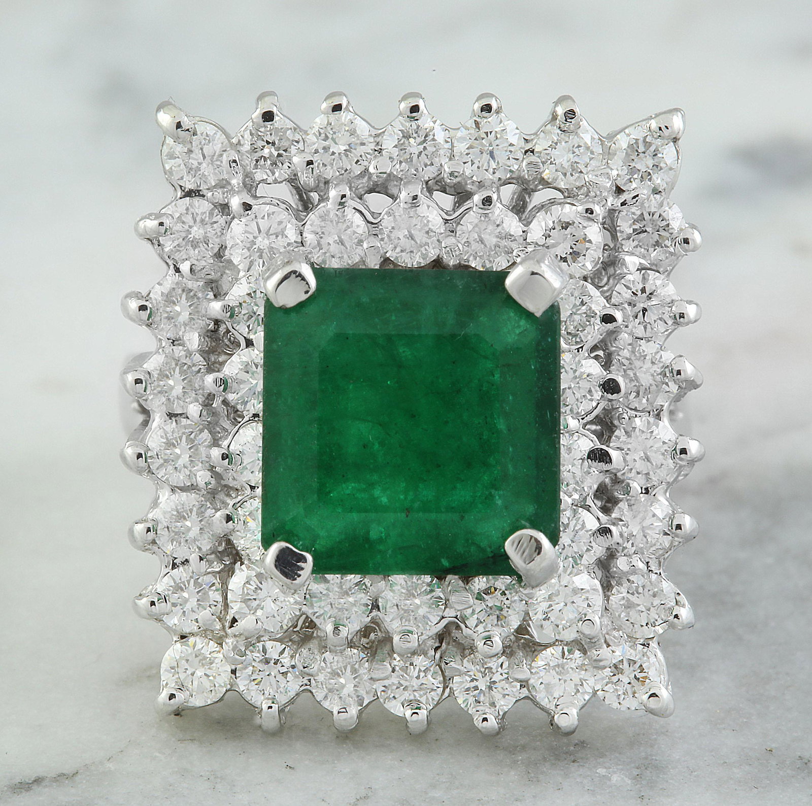 6.50 CTW Emerald 18K White Gold Diamond Ring: 6.50 CTW Emerald 18K White Gold Diamond Ring Manufacturer's Suggested Retail Price: $ 12150.00 Stamped: 18K Total Ring Weight: 11.4 Grams Emerald Weight 4.50 Carat (9.80x9.65 Millimeters) Diamond Weig