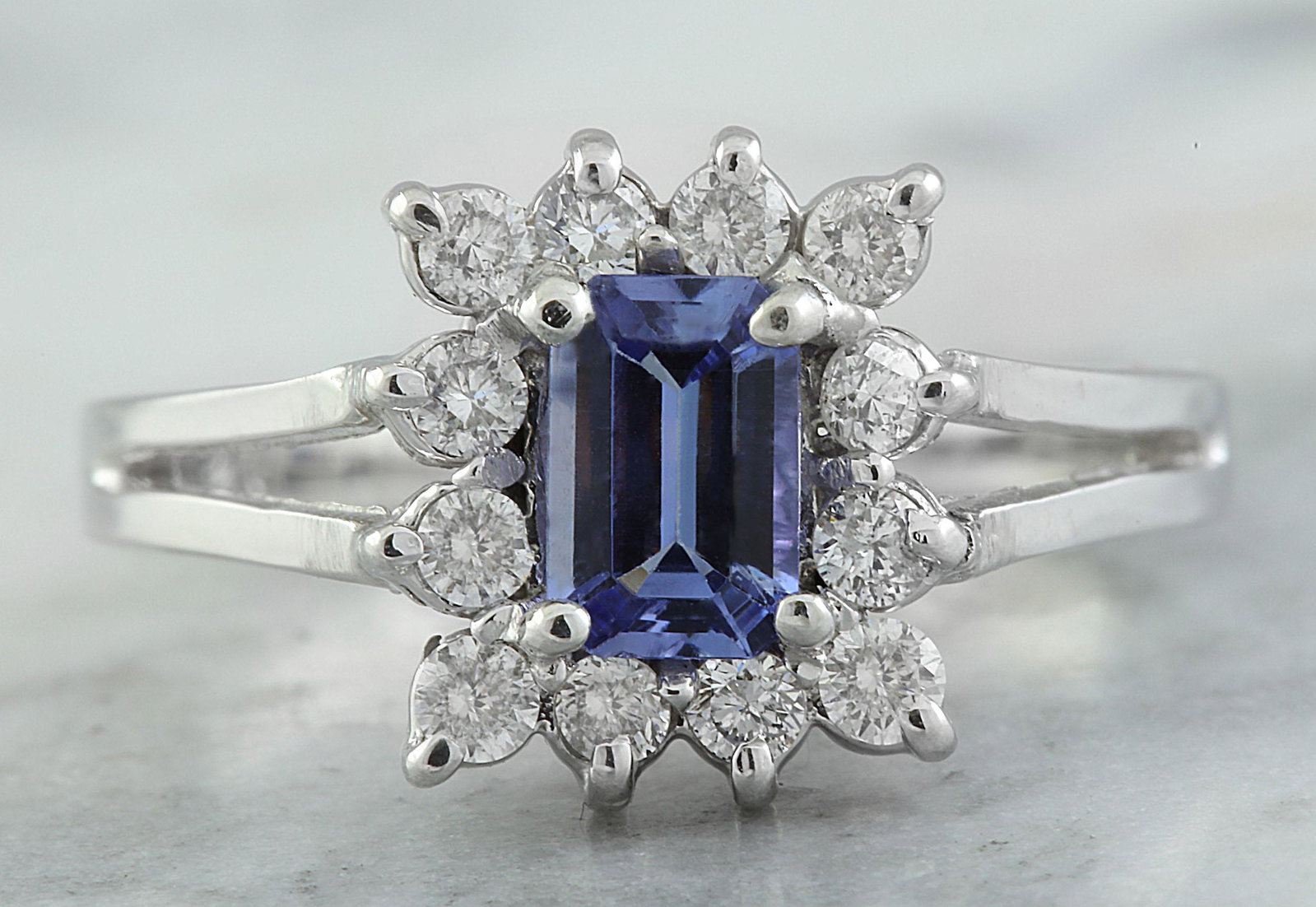 0.98 CTW Tanzanite 14K White Gold Diamond Ring: 0.98 CTW Tanzanite 14K White Gold Diamond Ring Manufacturer's Suggested Retail Price: $ 2100.00 Stamped: 14K Total Ring Weight: 3 Grams Tanzanite Weight: 0.70 Carat (6.00x4.00 Millimeters) Diamond Wei