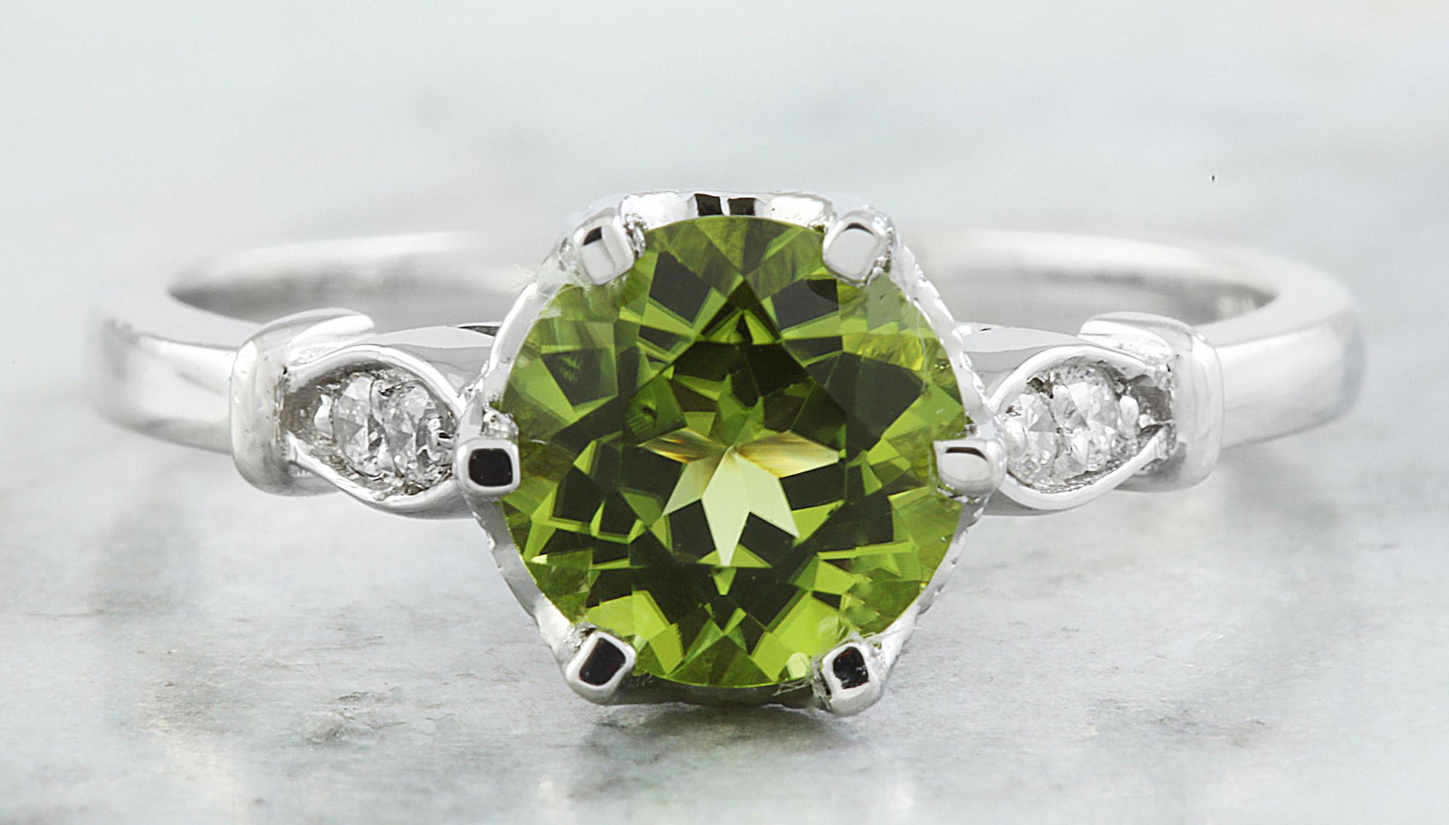 1.50 CTW Peridot 18K White Gold Diamond Ring: 1.50 CTW Peridot 18K White Gold Diamond Ring Manufacturer's Suggested Retail Price: $ 1900.00 Stamped: 18K Total Ring Weight: 3.4 Grams Peridot Weight 1.40 Carat (7.00x7.00 Millimeters) Diamond Weight