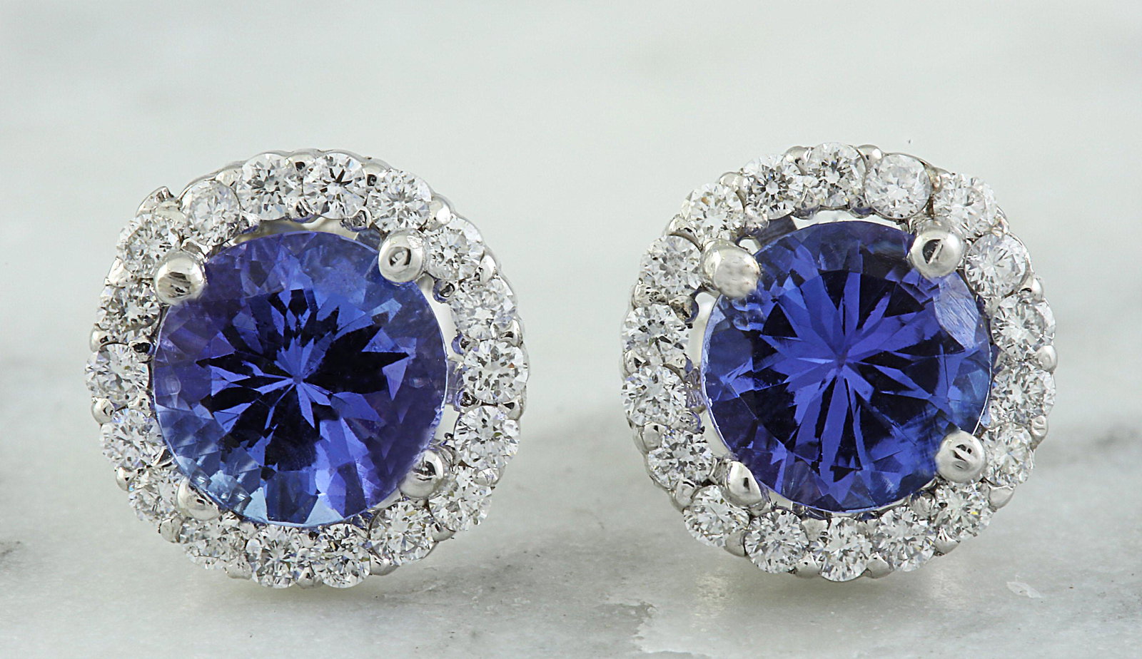 2.40 CTW Tanzanite 14K White Gold Diamond Earrings: 2.40 CTW Tanzanite 14K White Gold Diamond Earrings Manufacturer's Suggested Retail Price: $ 2800.00 Stamped: 14K Total Earrings Weight: 2 Grams Tanzanite Weight: 2.00 Carat (6.00x6.00 Millimeters) Dia