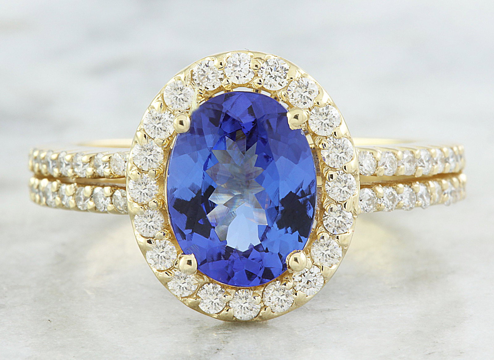 2.34 CTW Tanzanite 14K Yellow Gold Diamond Ring: 2.34 CTW Tanzanite 14K Yellow Gold Diamond Ring Manufacturer's Suggested Retail Price: $ 3000.00 Stamped: 14K Total Ring Weight: 4.9 Grams Tanzanite Weight 1.84 Carat ( 9.00x7.00 Millimeters) Diamond 