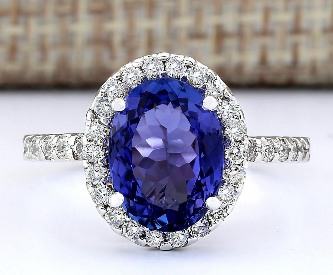 3.63 CTW Natural Blue Tanzanite And Diamond Ring 18K: 3.63 CTW Natural Blue Tanzanite And Diamond Ring 18K Solid White Gold Manufacturer's Suggested Retail Price: $ 4400.00 Stamped: 18K Ring Size: 6.75 Total Ring Weight: 3.9 Grams Diamond Weight: Total N