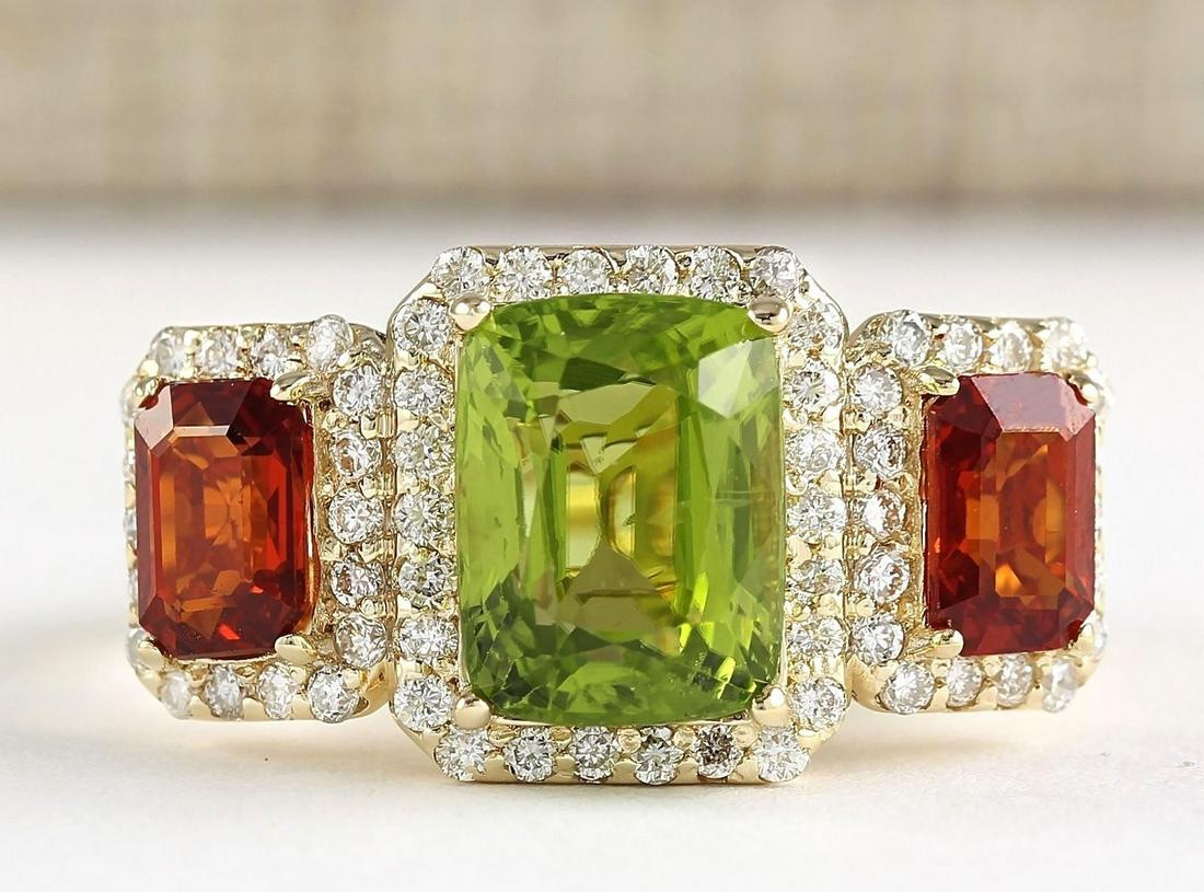 5.85 CTW Natural Peridot And Sapphire Diamond Ring In: 5.85 CTW Natural Peridot And Sapphire Diamond Ring In 14k Yellow Gold Manufacturer's Suggested Retail Price: $ 3700.00 Stamped: 14K Ring Size: 7 Total Ring Weight: 5 Grams Diamond Weight: Total Natura