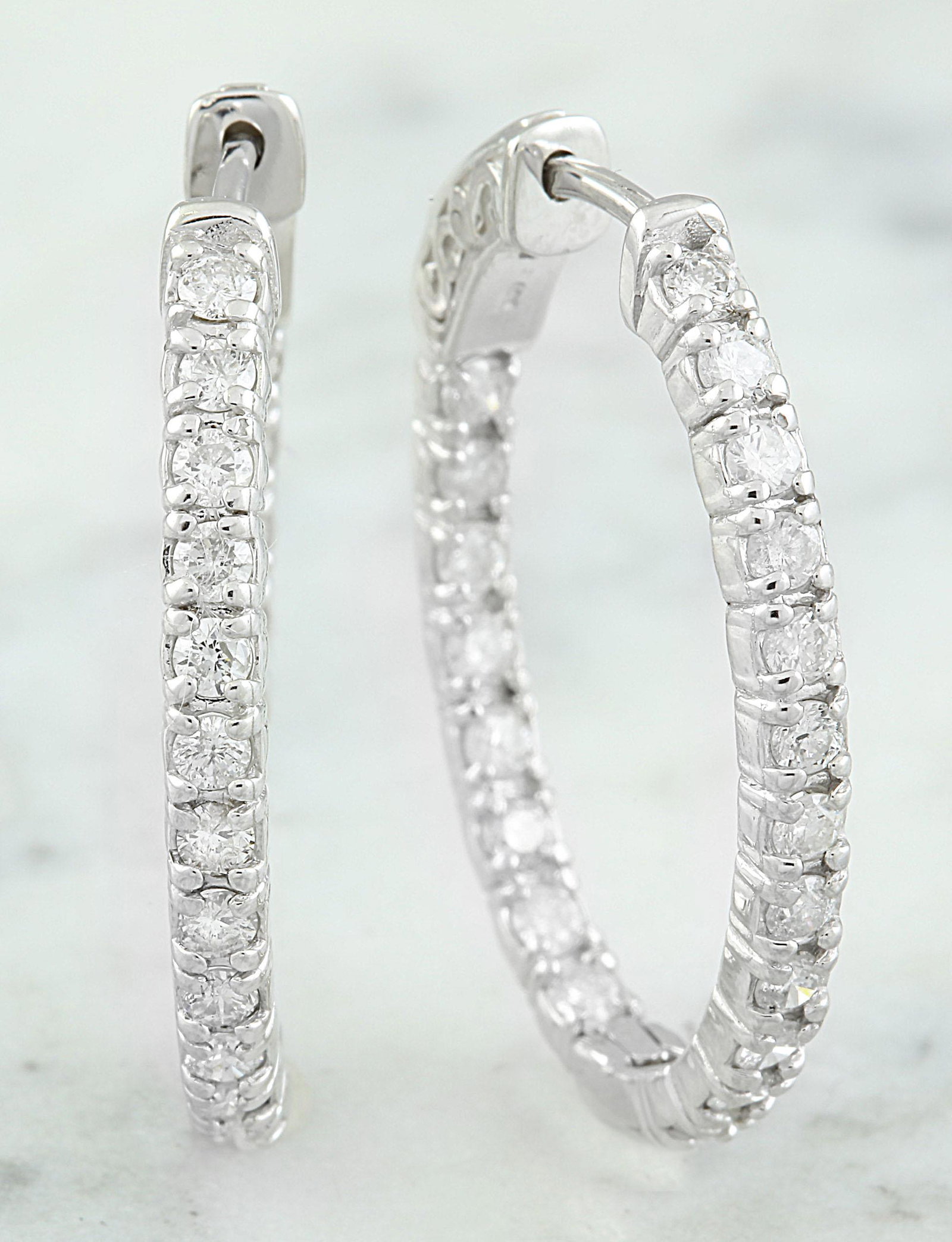 2.00 CTW 18K White Gold Diamond Hoop Earrings: 2.00 CTW 18K White Gold Diamond Hoop Earrings Manufacturer's Suggested Retail Price: $ 5400.00 Stamped: 18K Total Earrings Weight: 6.2 Grams Diamond Weight: 2.00 Carat (F-G Color, VS2-SI1 Clarity ) Di