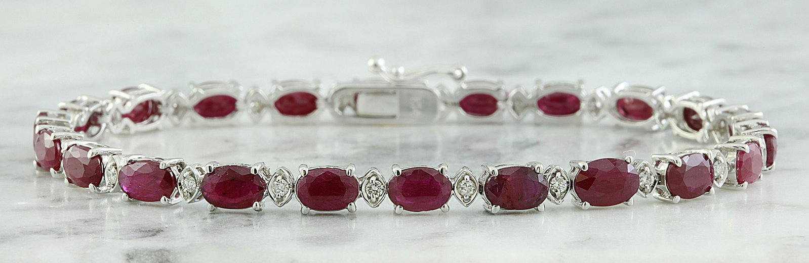 11.95 CTW Ruby 18K White Gold Diamond Bracelet: 11.95 CTW Ruby 18K White Gold Diamond Bracelet Manufacturer's Suggested Retail Price: $ 4100.00 Stamped: 18K Total Bracelet Weight: 11.1 Grams Bracelet Length: 7.0 Inches Ruby Weight: 11.45 Carat (6.0
