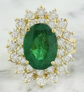 7.10 CTW Emerald 18K Yellow Gold Diamond Ring: 7.10 CTW Emerald 18K Yellow Gold Diamond Ring Manufacturer's Suggested Retail Price: $ 9300.00 Stamped: 18K Total Ring Weight: 9.8 Grams Emerald Weight 4.60 Carat (12.65x9.40 Millimeters)
