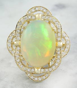 7.05 CTW Opal 14K Yellow Gold Diamond Ring: 7.05 CTW Opal 14K Yellow Gold Diamond Ring Manufacturer's Suggested Retail Price: $ 4000.00 Stamped: 14K Total Ring Weight: 7 Grams Opal Weight 6.55 Carat (16.00x12.00 Millimeters) Diamond