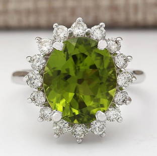 7.60 CTW Natural Peridot And Diamond Ring In 18K White Gold: 7.60 CTW Natural Peridot And Diamond Ring In 18K White Gold Manufacturer's Suggested Retail Price: $ 5100.00 Stamped: 18K Ring Size: 6.5 Total Ring Weight: 6.6 Grams Diamond Weight: Total