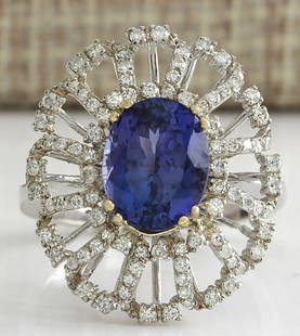 4.02 CTW Natural Blue Tanzanite And Diamond Ring 18K Solid White Gold: 4.02 CTW Natural Blue Tanzanite And Diamond Ring 18K Solid White Gold Manufacturer's Suggested Retail Price: $ 5300.00 Stamped: 18K Ring Size: 7.5 Total Ring Weight: 6.8 Grams Diamond