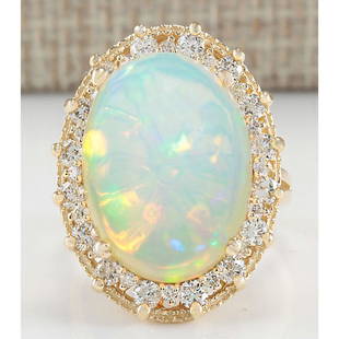 12.02 CTW Natural Opal And Diamond Ring In 14K Yellow Gold: 12.02 CTW Natural Opal And Diamond Ring In 14K Yellow Gold Manufacturer's Suggested Retail Price: $ 5400.00 Stamped: 14K Ring Size: 6.5 Total Ring Weight: 9 Grams Diamond Weight: Total