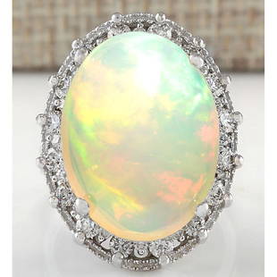 12.36 CTW Natural Opal And Diamond Ring In 18K White Gold: 12.36 CTW Natural Opal And Diamond Ring In 18K White Gold Manufacturer's Suggested Retail Price: $ 5900.00 Stamped: 18K Ring Size: 6 Total Ring Weight: 8 Grams Diamond Weight: Total