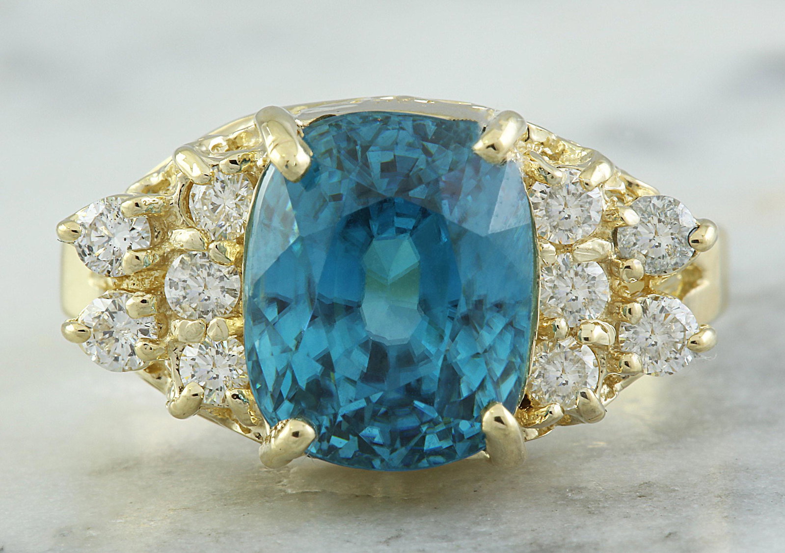 7.12 CTW Zircon 14K Yellow Gold Diamond Ring: 7.12 CTW Zircon 14K Yellow Gold Diamond Ring Manufacturer's Suggested Retail Price: $ 3300.00 Stamped: 14K Ring Size: 7 Total Ring Weight: 5.1 Grams Zircon Weight: 6.67 Carat (9.75x7.90 Millimeter) Di