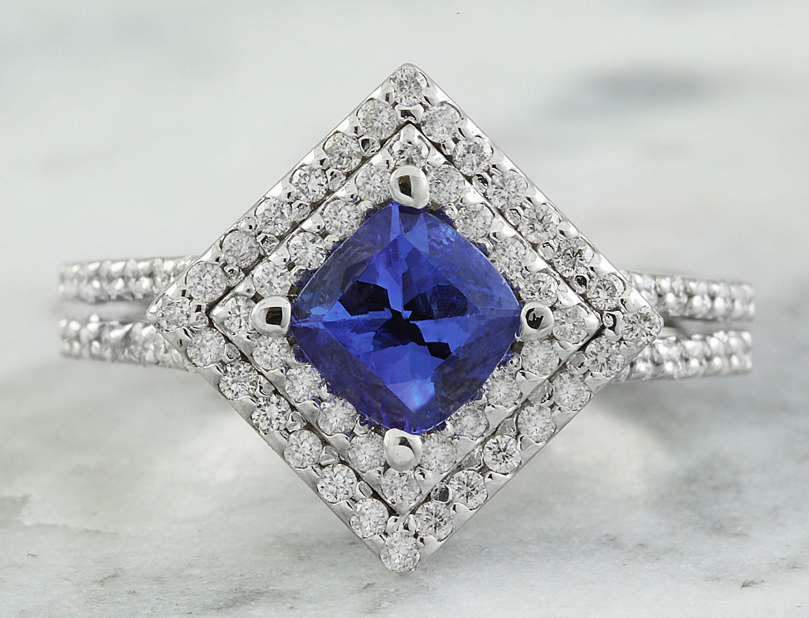2.00 CTW Tanzanite 14K White Gold Diamond Ring: 2.00 CTW Tanzanite 14K White Gold Diamond Ring Manufacturer's Suggested Retail Price: $ 3400.00 Stamped: 14K Total Ring Weight: 5.8 Grams Tanzanite Weight: 1.00 Carat (6.00x6.00 Millimeters) Diamond W